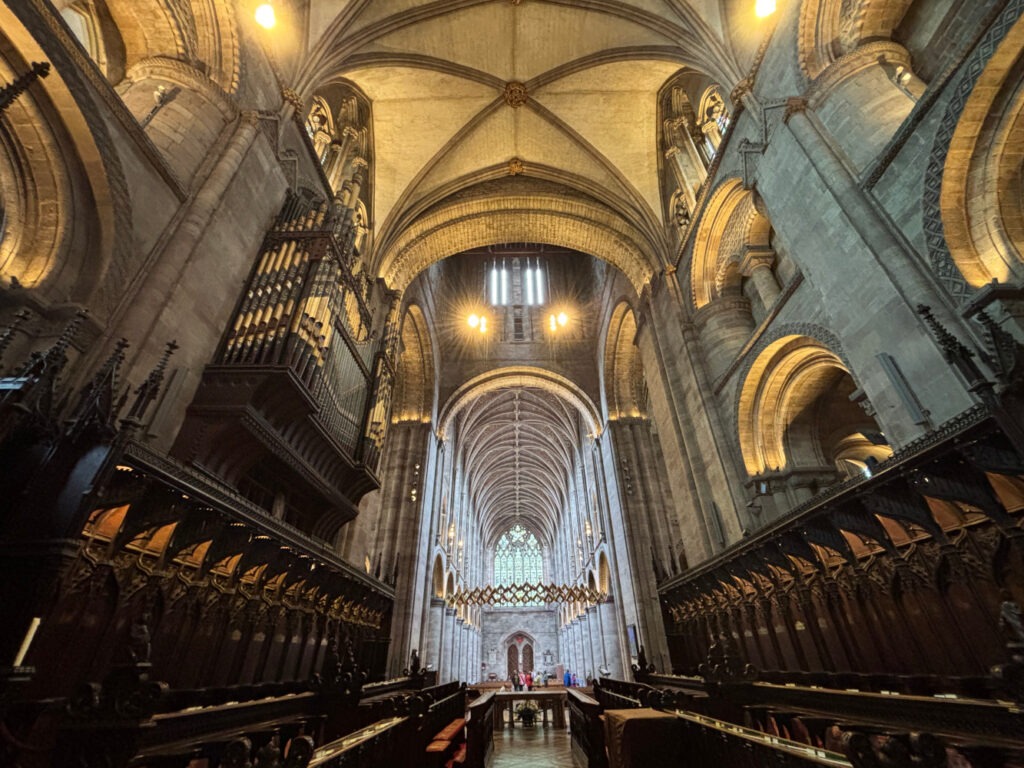 An interior view towards the west end of Hereford Cathedral, with the organ case to the left.