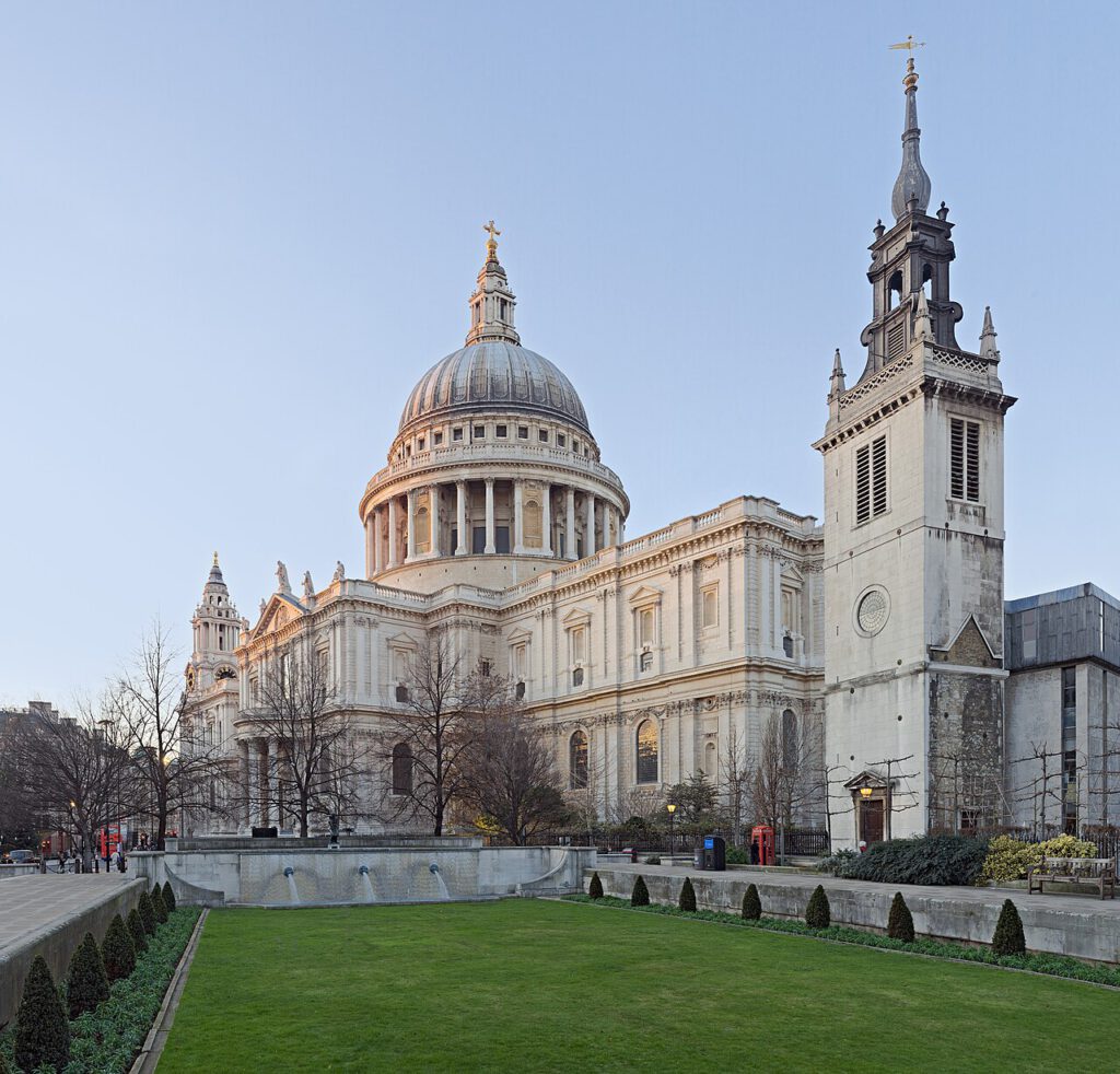 The exterior of St Paul's Cathedral, with the church tower of St Augustine, Watling Street, in the foreground.