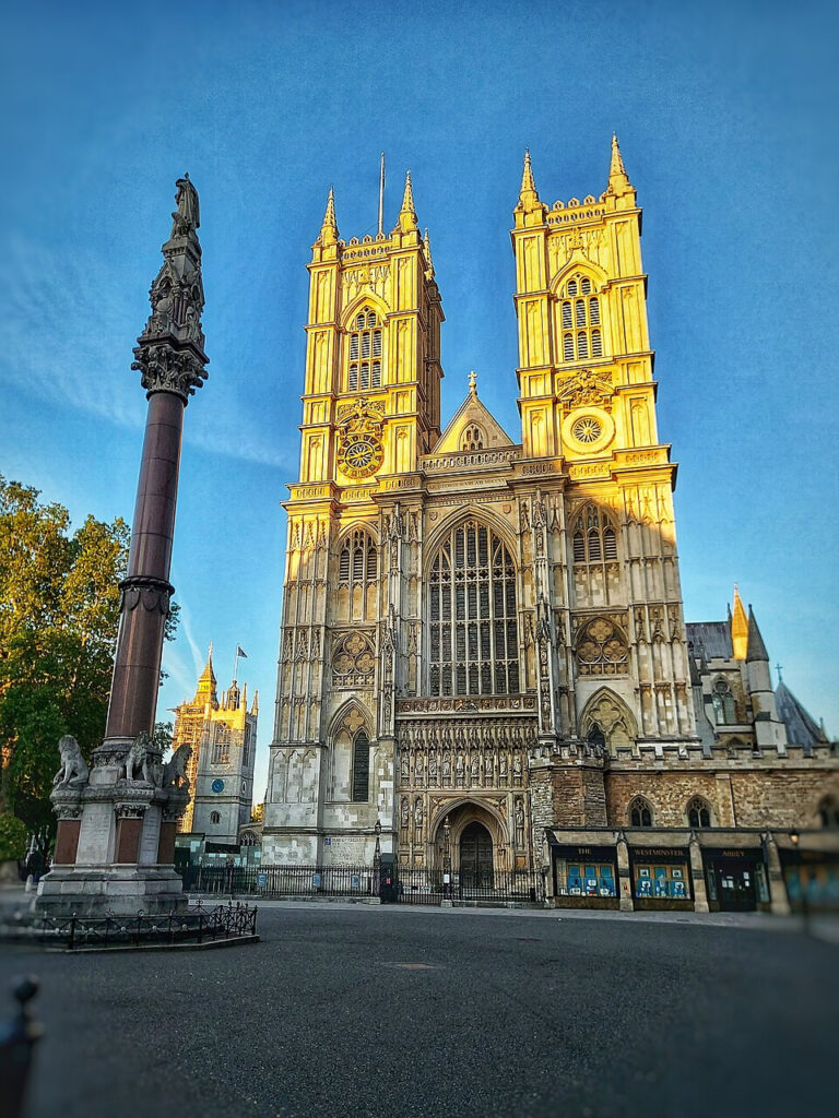 The west front of Westminster Abbey, bathed in sunlight.