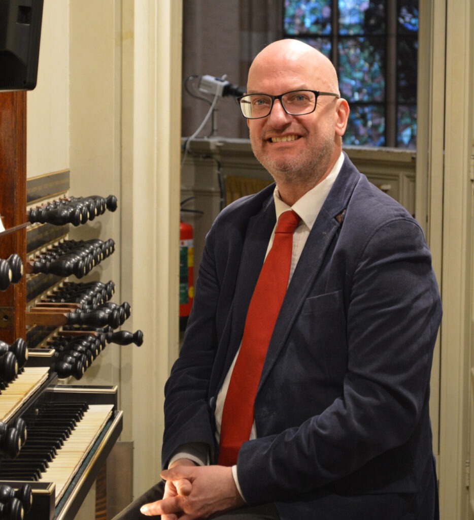 Organist Jan Hage at the console of the organ of Utrecht Domkerk.